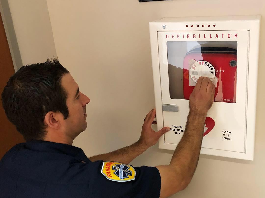 firefighter closes AED box